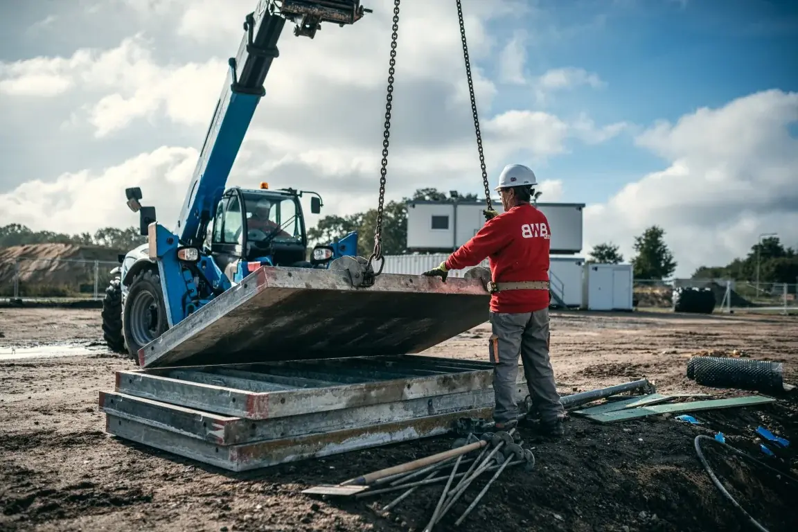 A crane lifting concrete slabs on a construction site